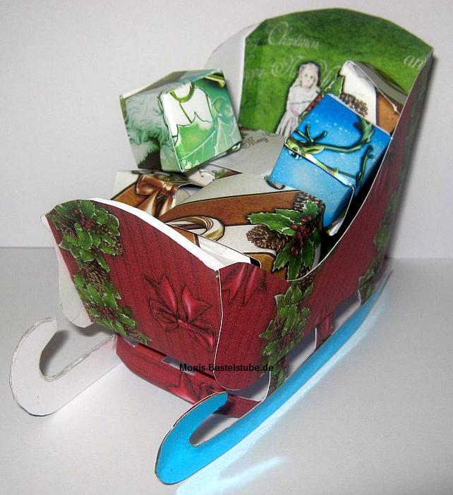 Weihnachtsschlitten-mit-Geschenken-DebbiMoore-Santa-Claus.jpg